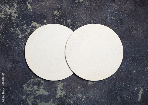 Photo of two blank beer coasters on concrete background. Top view. Flat lay.