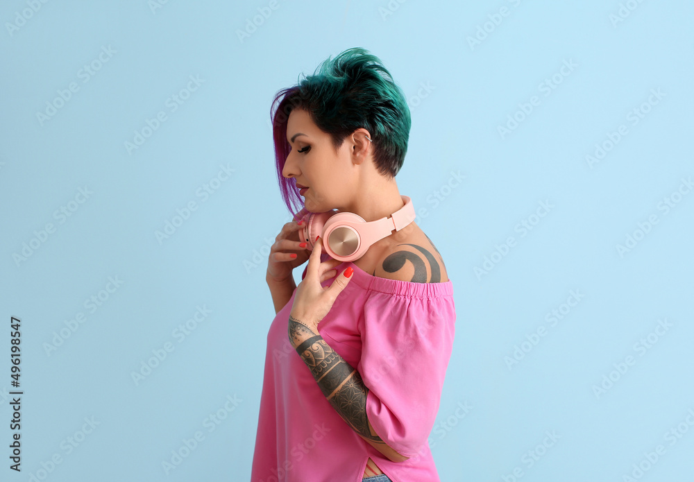 Beautiful woman with unusual hair and headphones on color background Beautiful woman with unusual hair and headphones on color background