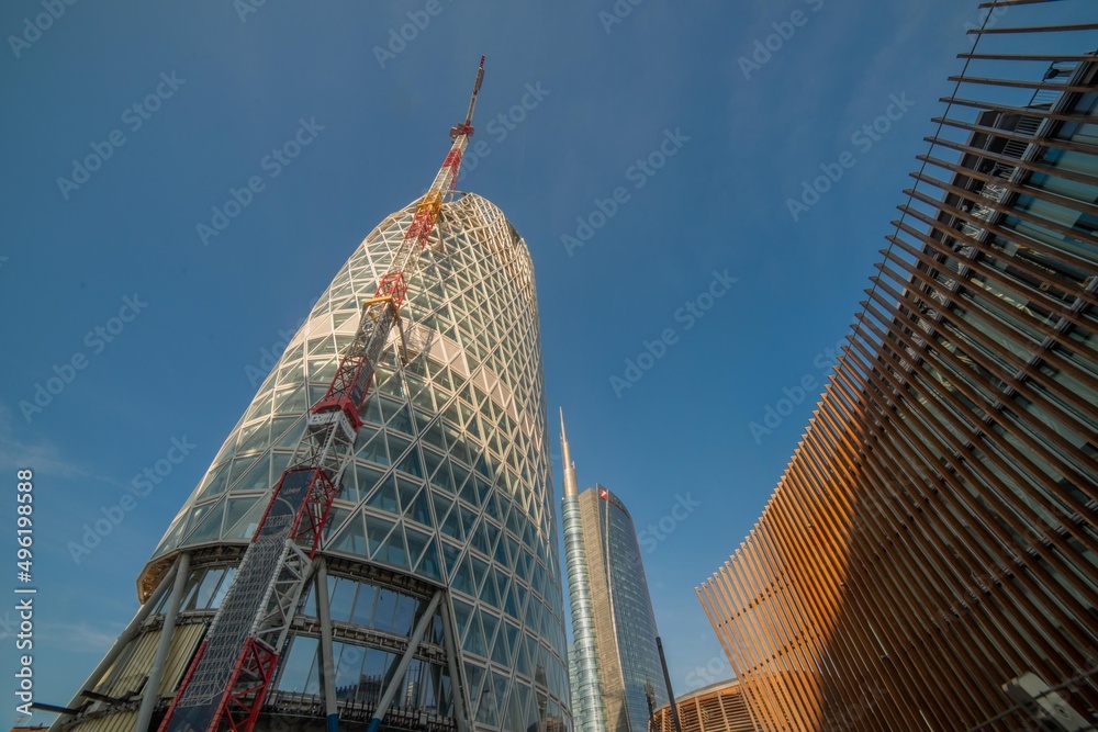 Naklejka premium Milan Italy 2 March 2022 Futurist construction of the Piazza Gae Aulenti is in complete harmony with the surrounding buildings