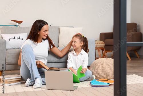 Cute girl studying with tut...
