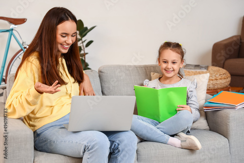 Cute girl studying with tut...