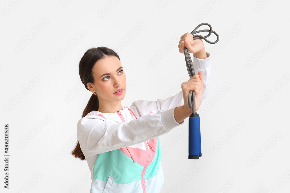 Sporty young woman with skipping rope on white background. Immunity concept Sporty young woman with skipping rope on white background. Immunity concept