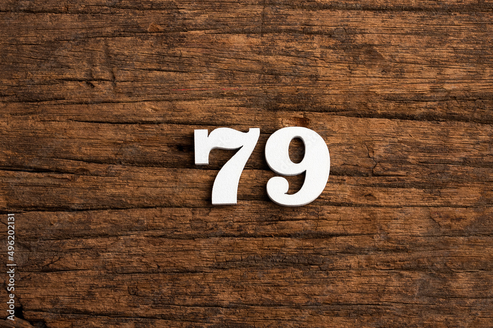 Obraz premium Number 79 in wood, isolated on rustic background