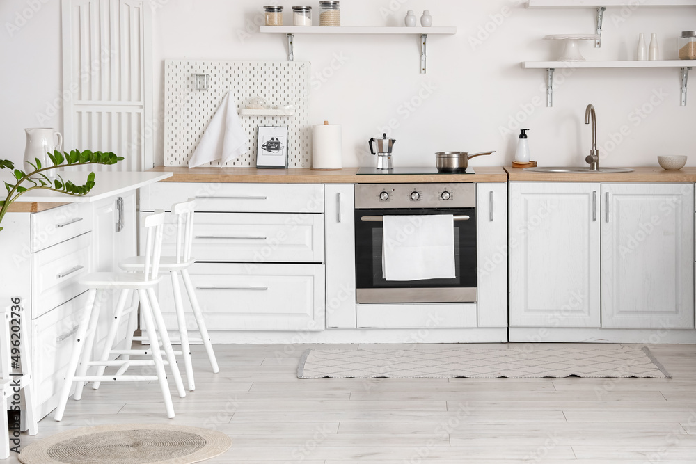 Stylish interior of light kitchen with counters and chairs Stylish interior of light kitchen with counters and chairs