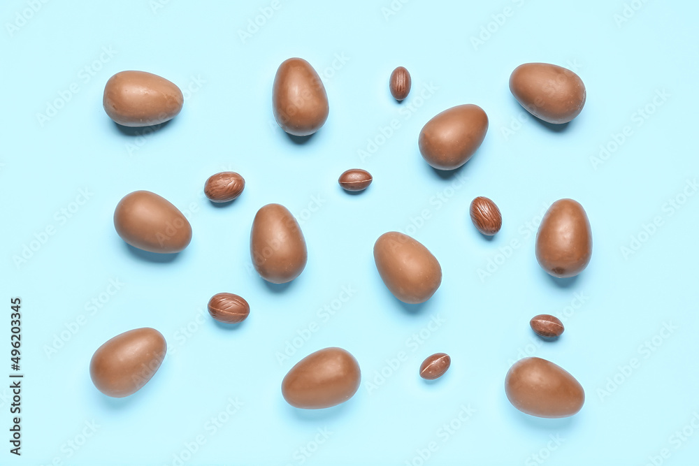 Delicious chocolate eggs on blue background