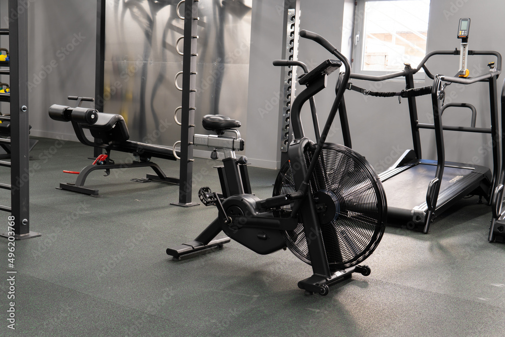 Obraz premium Air bike gym exercise fit, from female endurance from lifestyle and club equipment, person power. Sportswear exercising riding, determined