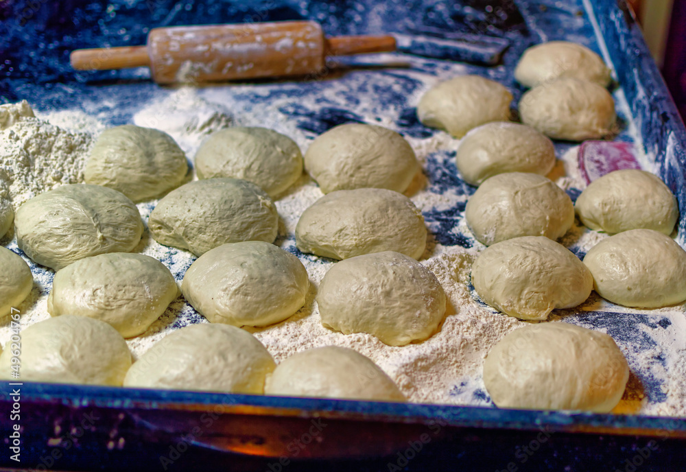 Fototapeta premium Fresh bread dough standing among floor ready for baking