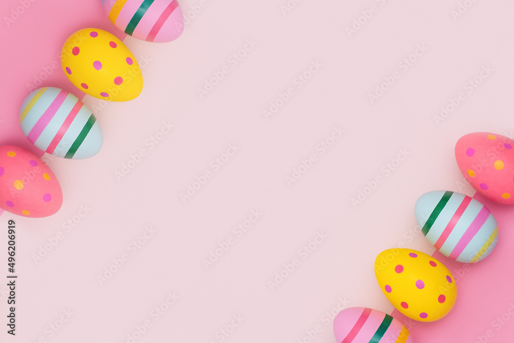 Vivid Easter eggs in retro style on a pink background with copy space. Easter eggs in two row diagonally on a two-tone backdrop in pink hues. Happy Easter card.