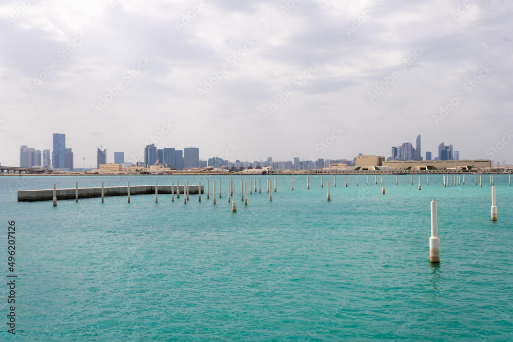Abu Dhabi skyline in UAE, water in the foreground