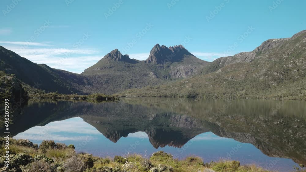 wide shot of cradle mountain reflected on dove lake on a calm summer morning at cradle mountain national park of tasmania, australia wide shot of cradle mountain reflected on dove lake on a calm summer morning at cradle mountain national park of tasmania, australia