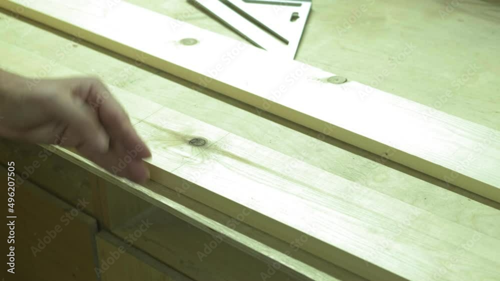 Action. A professional carpenter is working on a project in his workshop. Industrial woodworking machine. Action. A professional carpenter is working on a project in his workshop. Industrial woodworking machine.