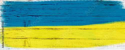 the concept of the Ukrainian flag on a wooden white background.