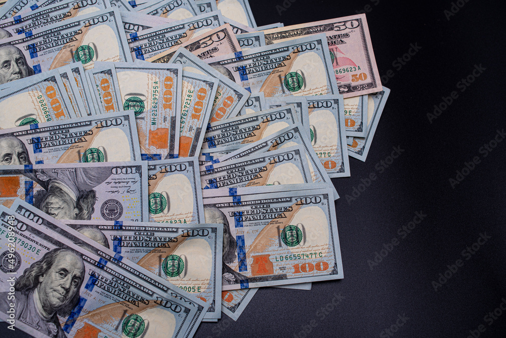 American dollars on a black background. Finance and business. American dollars on a black background. Finance and business.