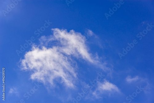 Blue sky and stretched  flat clouds.