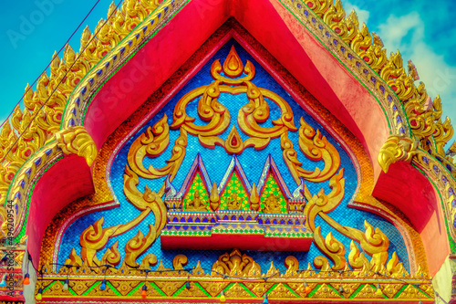 Colourful traditional decorations at Buddhist temple structures in Thailand.