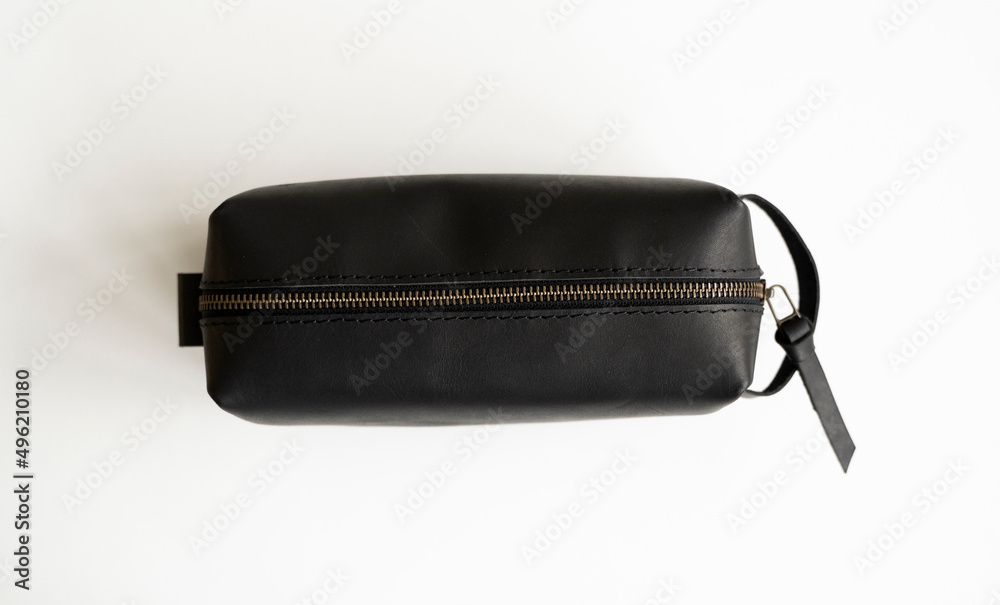 Man's black leather personal cosmetic bag or pouch for toiletry accessory. Style, retro, fashion, vintage and elegance. Man's black leather personal cosmetic bag or pouch for toiletry accessory. Style, retro, fashion, vintage and elegance.