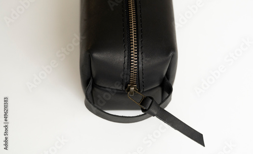 Close up, details of man's black leather personal cosmetic bag or pouch for toiletry accessory. Style, retro, fashion, vintage and elegance.