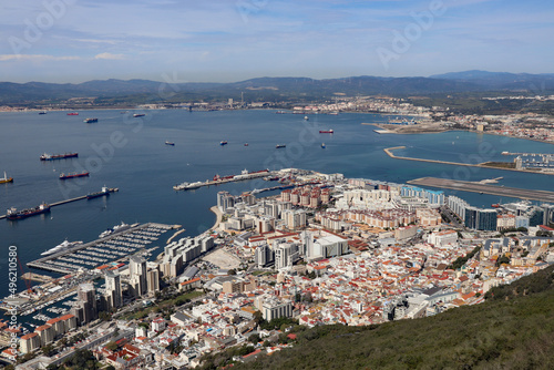 Panoramic view over Gibraltar harbour from the top of the Rock of Gibraltar. The airport runway juts out into the water.
