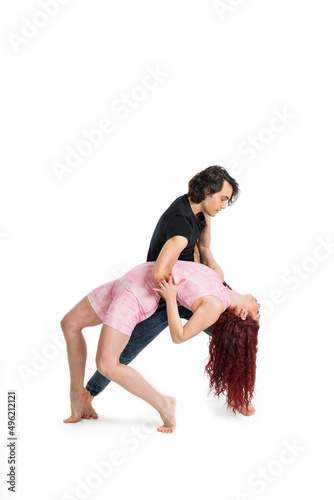 Boy and girl dancing on white background
