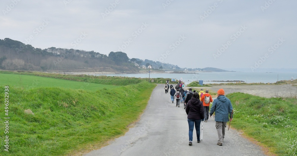 Group of senior hikers walking on a path in Brittany. France Group of senior hikers walking on a path in Brittany. France