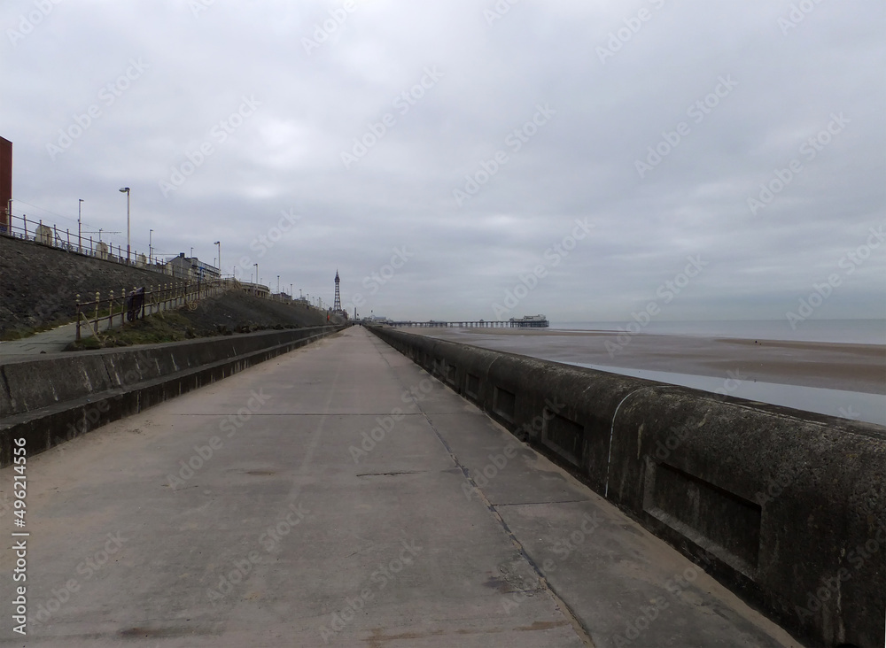 perspective view along the pedestrian promenade in blackpool with a view of the town south pier and tower in the distance