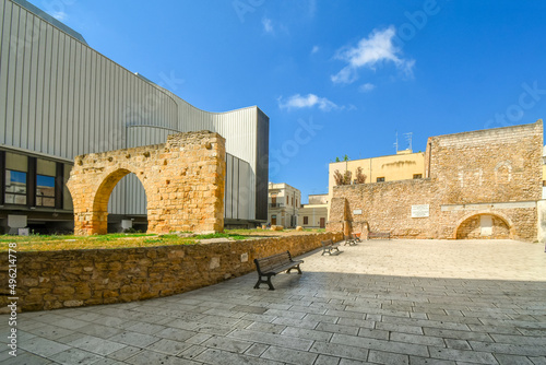 The Piazza Sottile de Falco with ancient Roman wall and arch in front of the Saint Pietro of Schiavoni Archaelogical museum and site in Brindisi Italy in the Puglia Region.