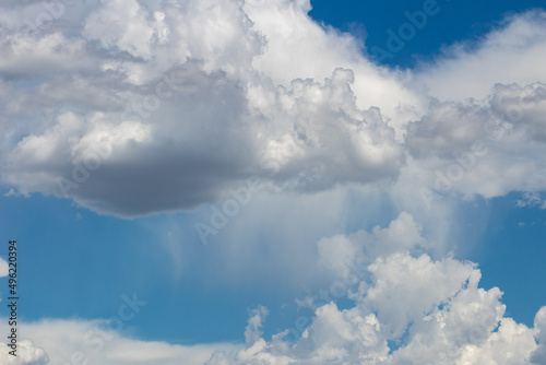 Beautiful white and gray clouds against a beautiful blue desert sky in the American Southwest. Large puffy and wispy cloudscapes, fresh clean air. © Charles