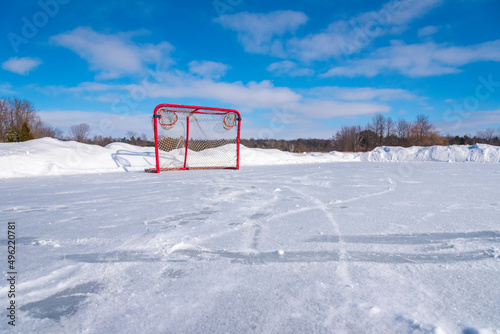 A low angle view of a hockey goal. The net is sitting on a frozen pond used to play shinny  is located in Stouffville Ontario Canada. Shinny is a pick up game of hockey with no formal rules. photo