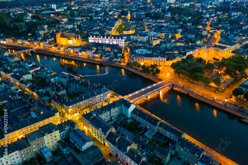 Evening aerial view of Laval with buildings, river Mayenne and old bridge, Mayenne department, north-western France