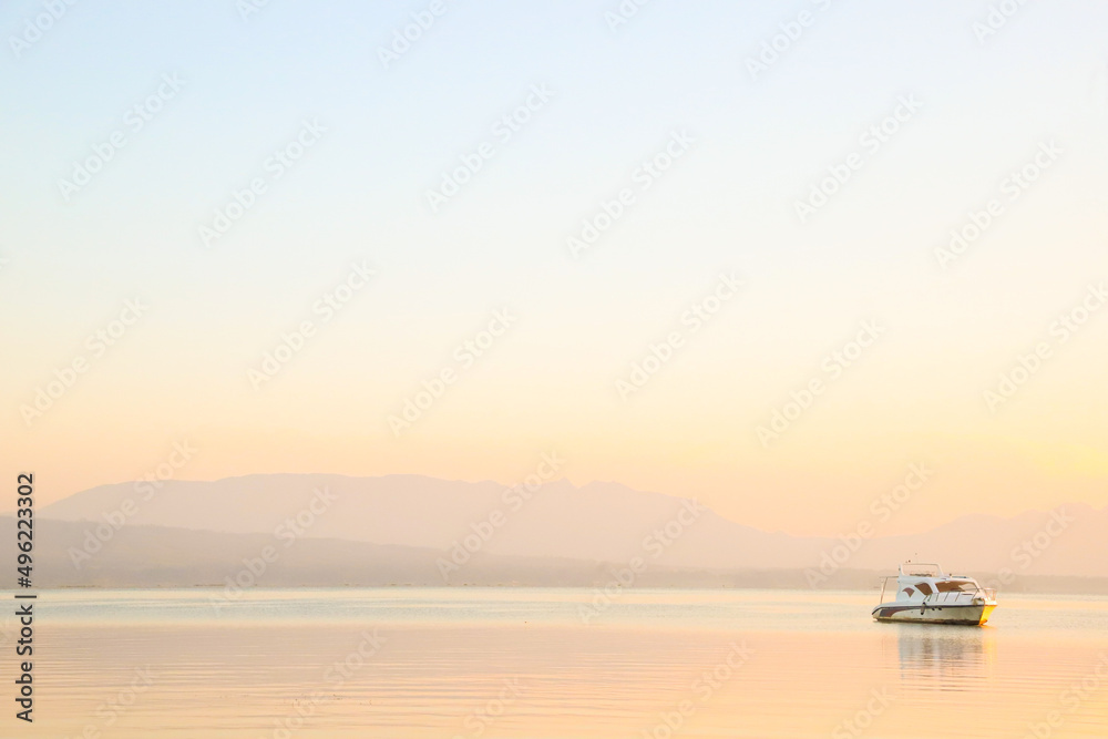 Naklejka premium cool background with boats on lake toba in the morning