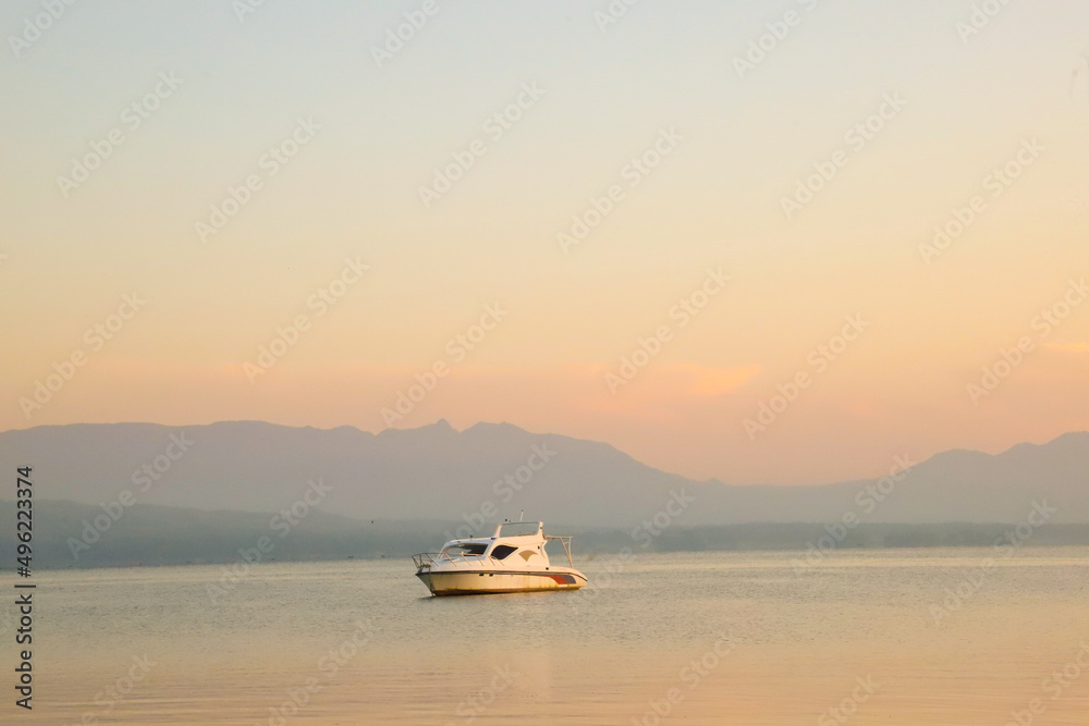 Lake Toba Background with Ship at sunrise with golden clouds
