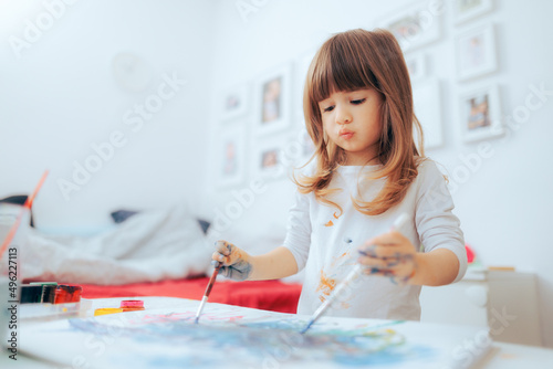 Photos Ambidextrous Little Child Painting with Both Hands