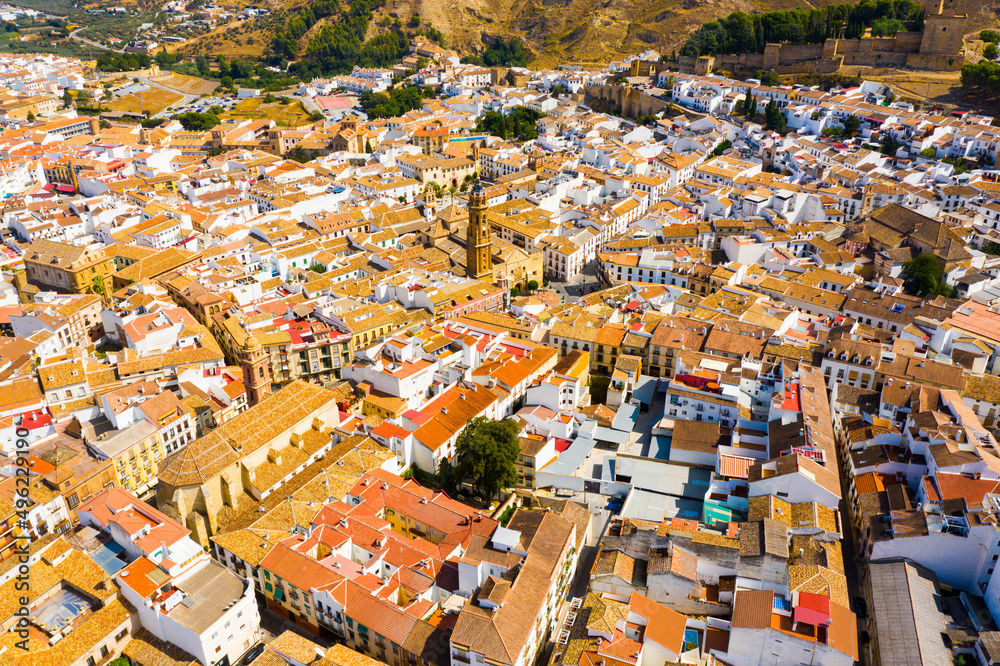 Aerial view of Antequera cityscape with ancient fortified castle and church, Spain