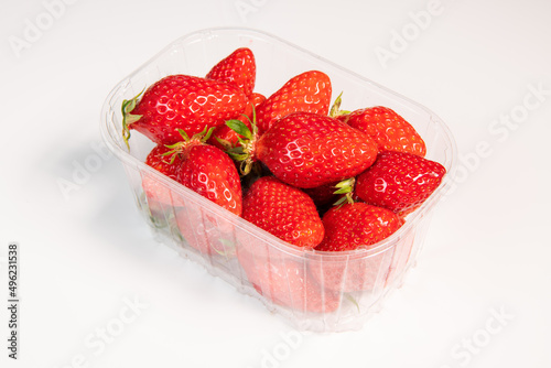 Punnet of strawberries isolated on white background photo