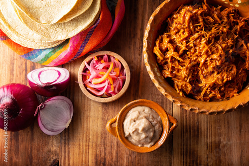 Cochinita Pibil. Typical Mexican stew from Merida, Yucatan, made from pork marinated with achiote and generally accompanied with beans and red onion with habanero chili, it can be eaten in tacos. photo