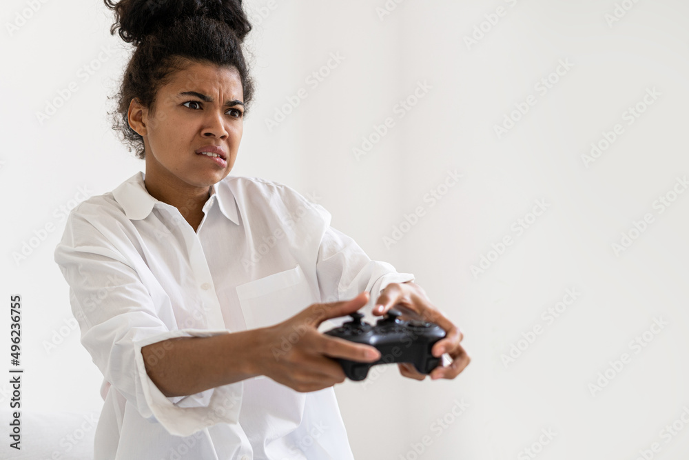 African woman playing video game with joystick African woman playing video game with joystick