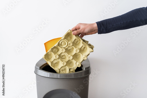 Deliberate person throwing paper in special trashbin photo