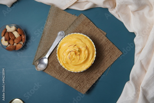 Top Shot Of Kesar Shrikhand with Green Background and White Cloth photo
