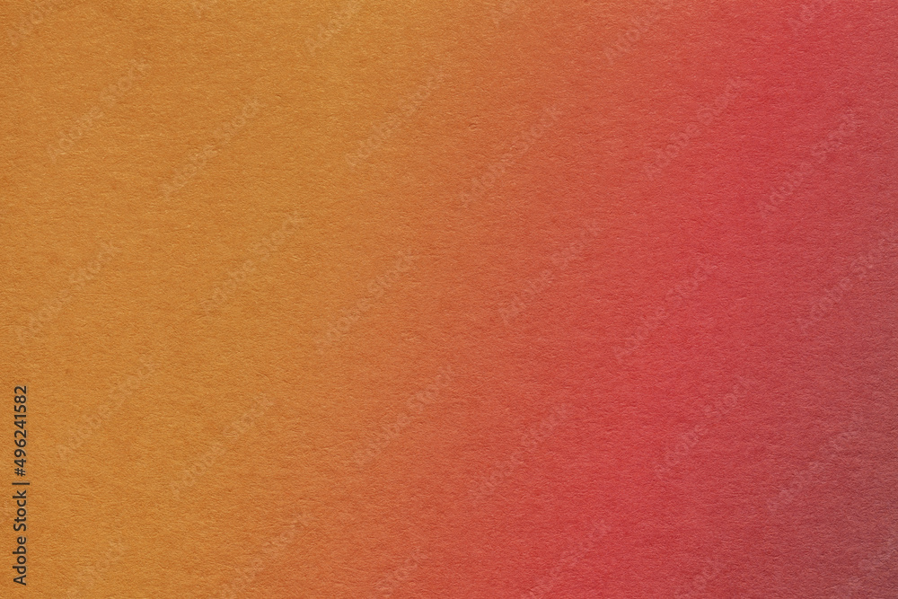 Fototapeta premium Texture of old dark red and orange colors paper background with soft gradient, macro.