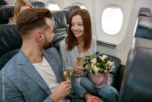 Happy couple in love celebrating anniversary in airplane