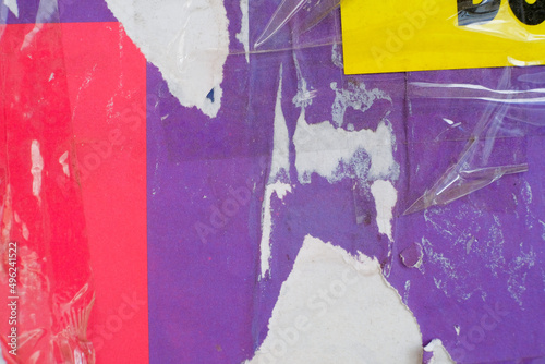 Grungy street poster background. Torn and ripped paper texture. Abstract collage layers of vintage street poster.