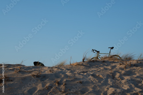 Man and bike observing the beach in the sand dunes of Carcans small swimming station on the french atlantic coast, near lacanau and bordeaux photo