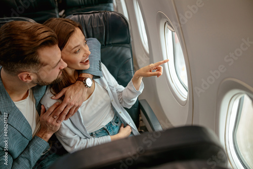 Konstfotografi Happy couple in love looking out the window in plane