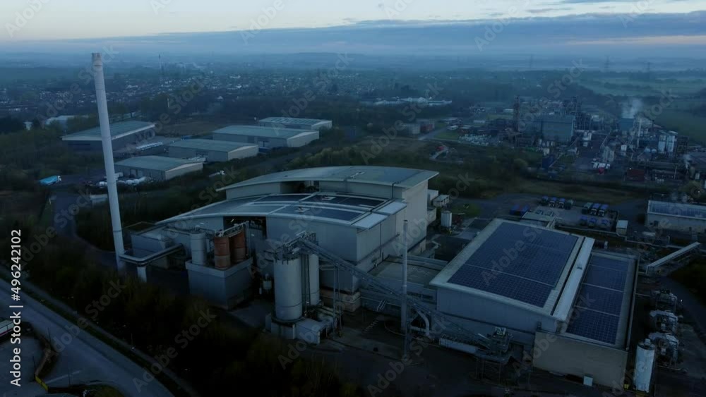 Futuristic solar green energy factory rooftop on foggy rural countryside morning aerial view descending Futuristic solar green energy factory rooftop on foggy rural countryside morning aerial view descending