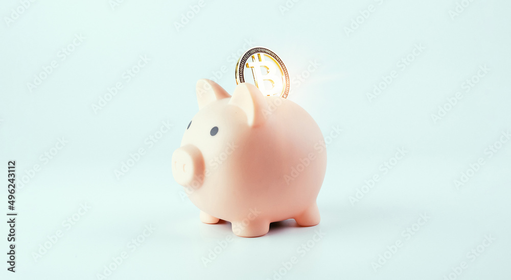 Obraz premium Save currency bitcoin. Pink pig bank with golden bit coin money BTC on white background. Save money investment and business finance.