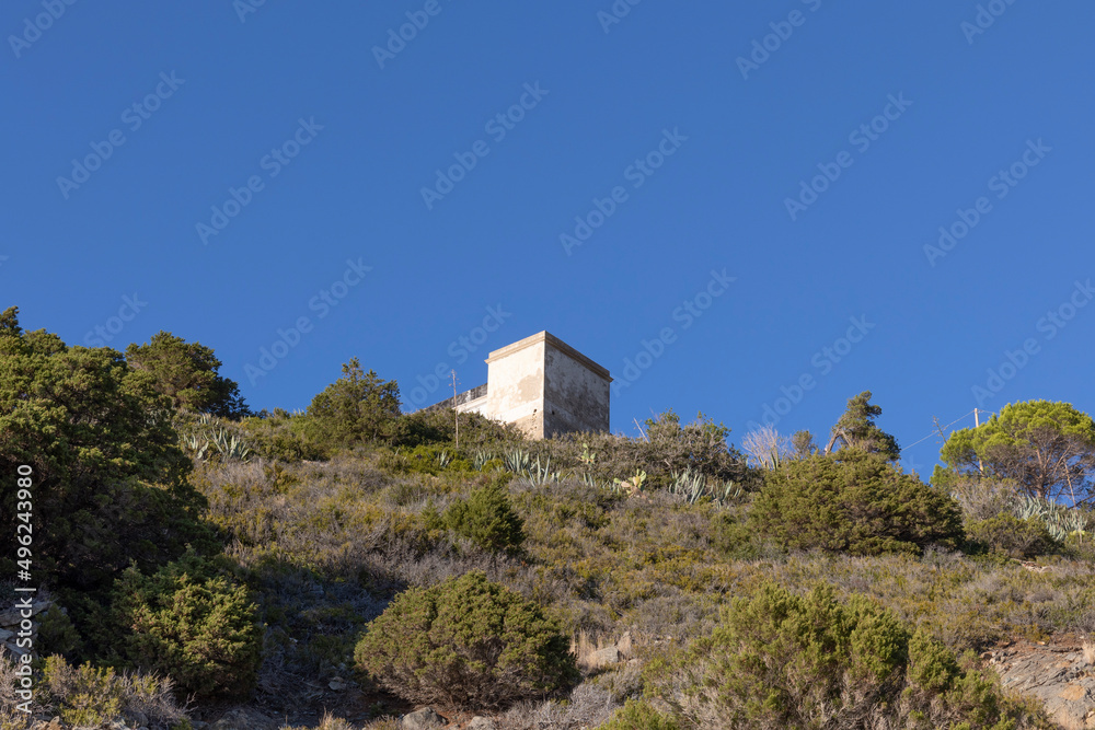 Lighthouse on the rocky coast in the small coastal town of Patresi on the island of Elba in Italy