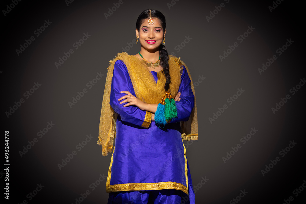 Portrait of Sikh woman standing with arms crossed and looking at camera Portrait of Sikh woman standing with arms crossed and looking at camera
