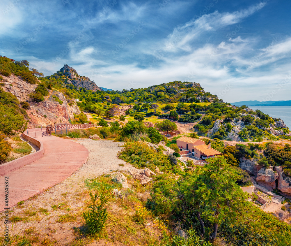 Bright summer view of West Court of Heraion of Perachora  with Agios Ioannis Church. Picturesque morning scene of outskirts of Limni Vouliagmenis town, Greece, Europe. Traveling concept background.
