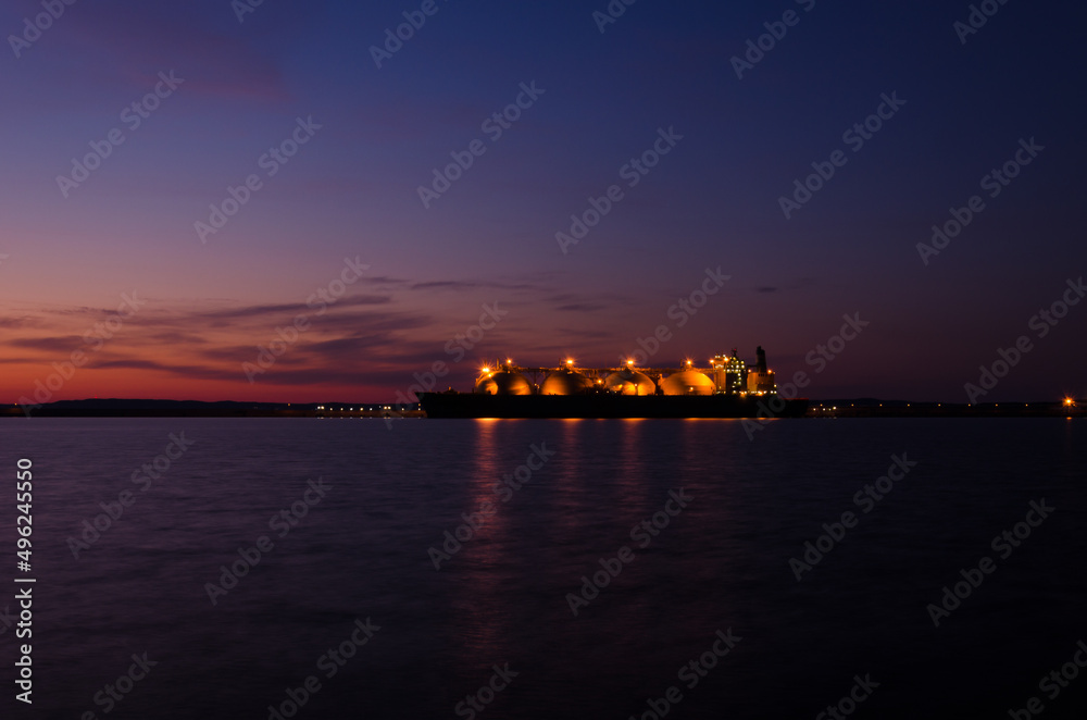 LNG TANKER - Ship at the gas terminal with sunrise LNG TANKER - Ship at the gas terminal with sunrise