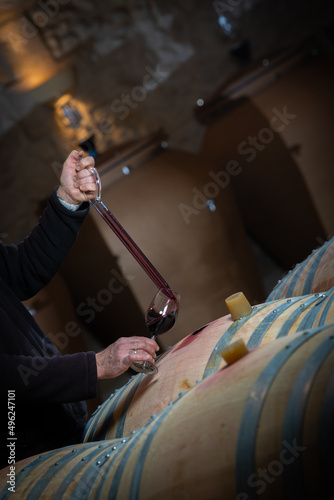 FRANCE, GIRONDE, SAINT-EMILION, SAMPLING A GLASS OF WINE IN A BARREL WITH A PIPETTE FOR TASTING AND VINIFICATION MONITORING, HIGHT QUALITY PHOTO